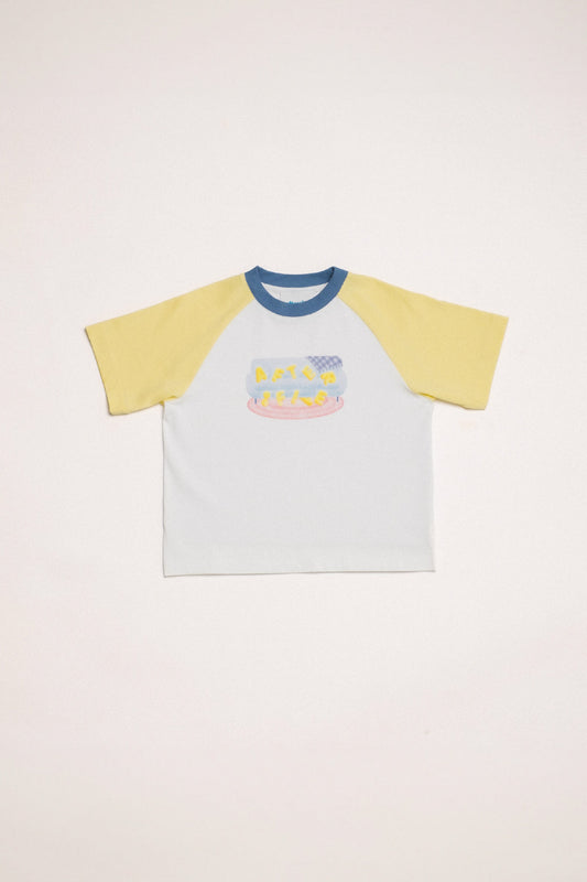 In Reverie Tee in white with yellow raglan sleeves and a ribbed blue neckline